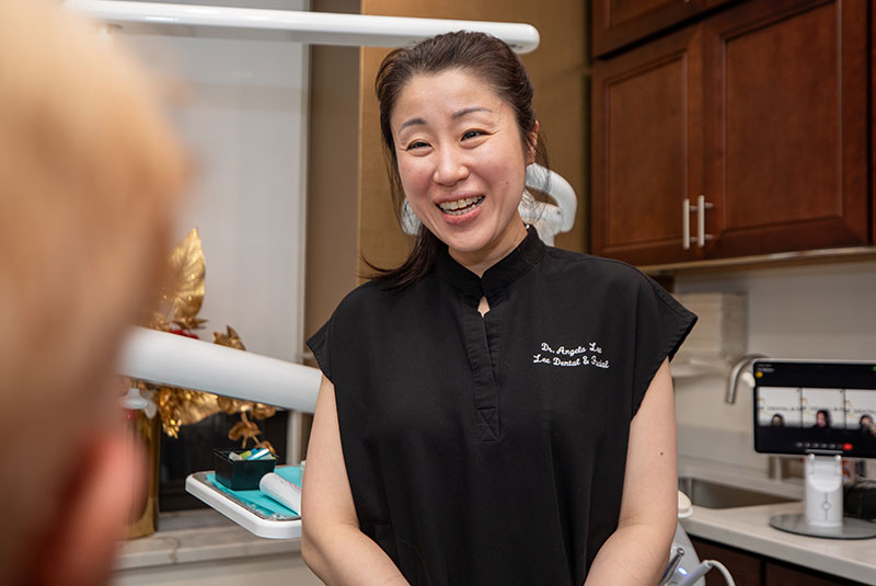 dr lee talking to blonde hair man dental implant process