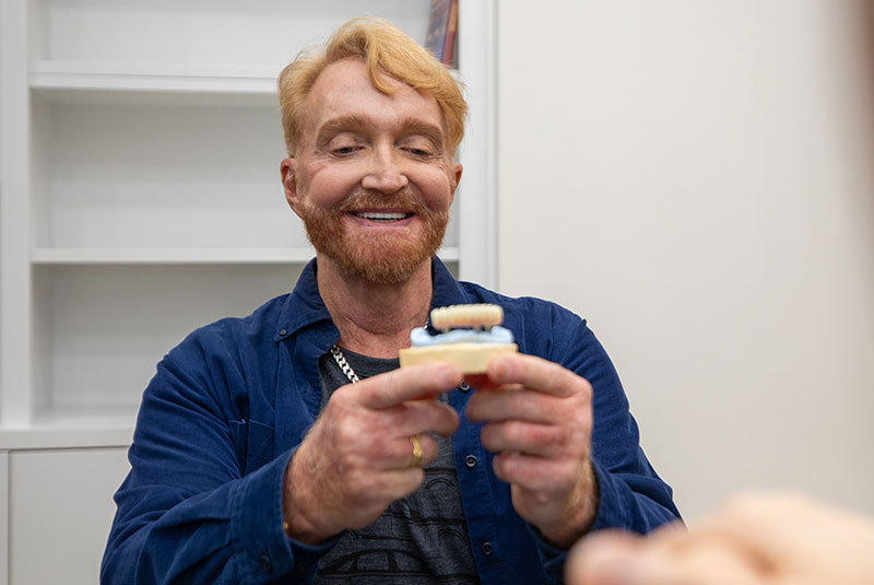 full arch dental patient looking over arch