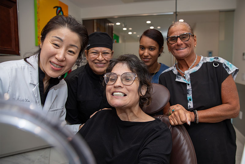 dr lee with team and dental patient