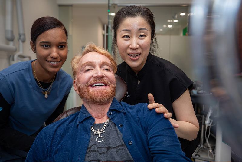 dr with dental full arch implant patient