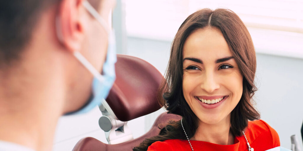 smiling dental patient red shirt