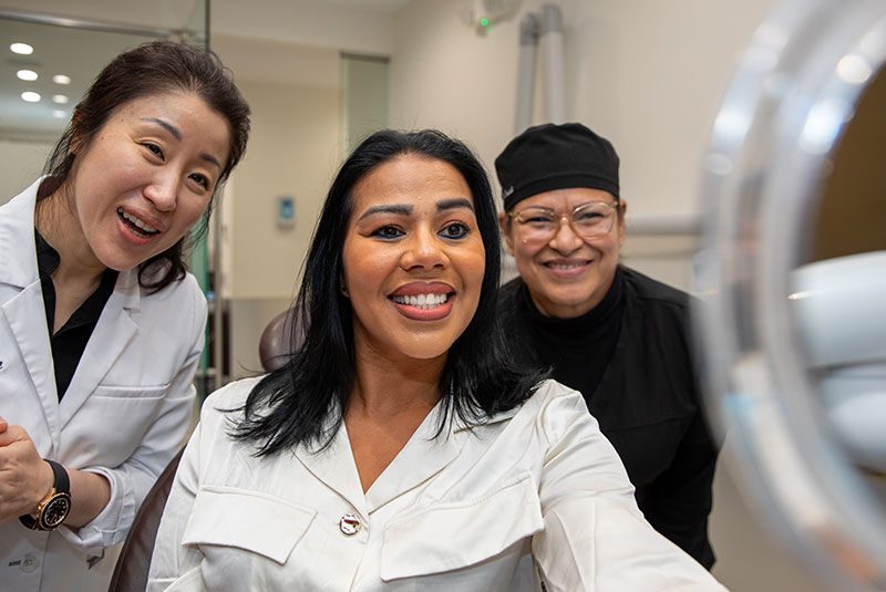 doctor and patient smiling into mirror